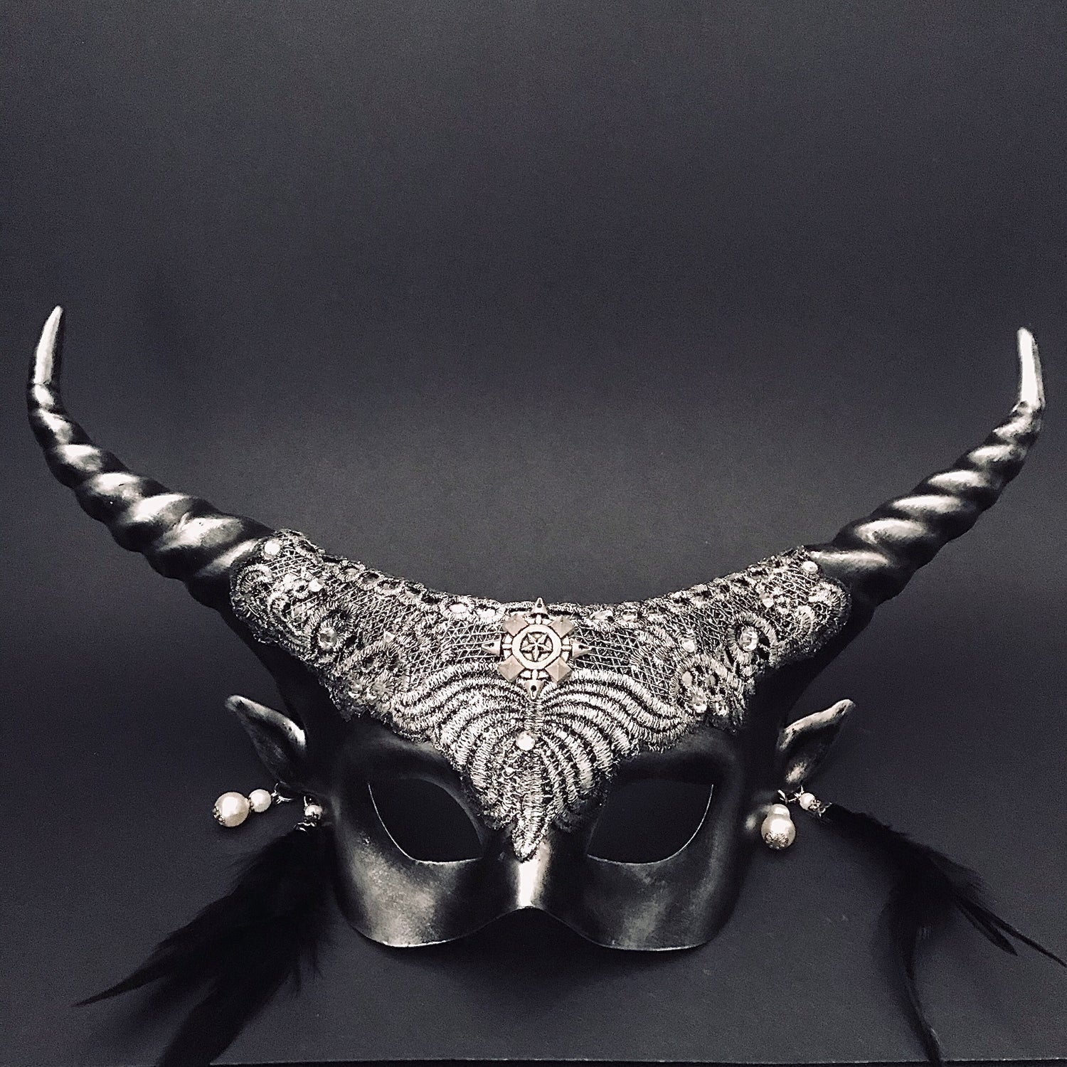 Black and Silver Horned Lace masquerade mask with delicate detailing and feathers