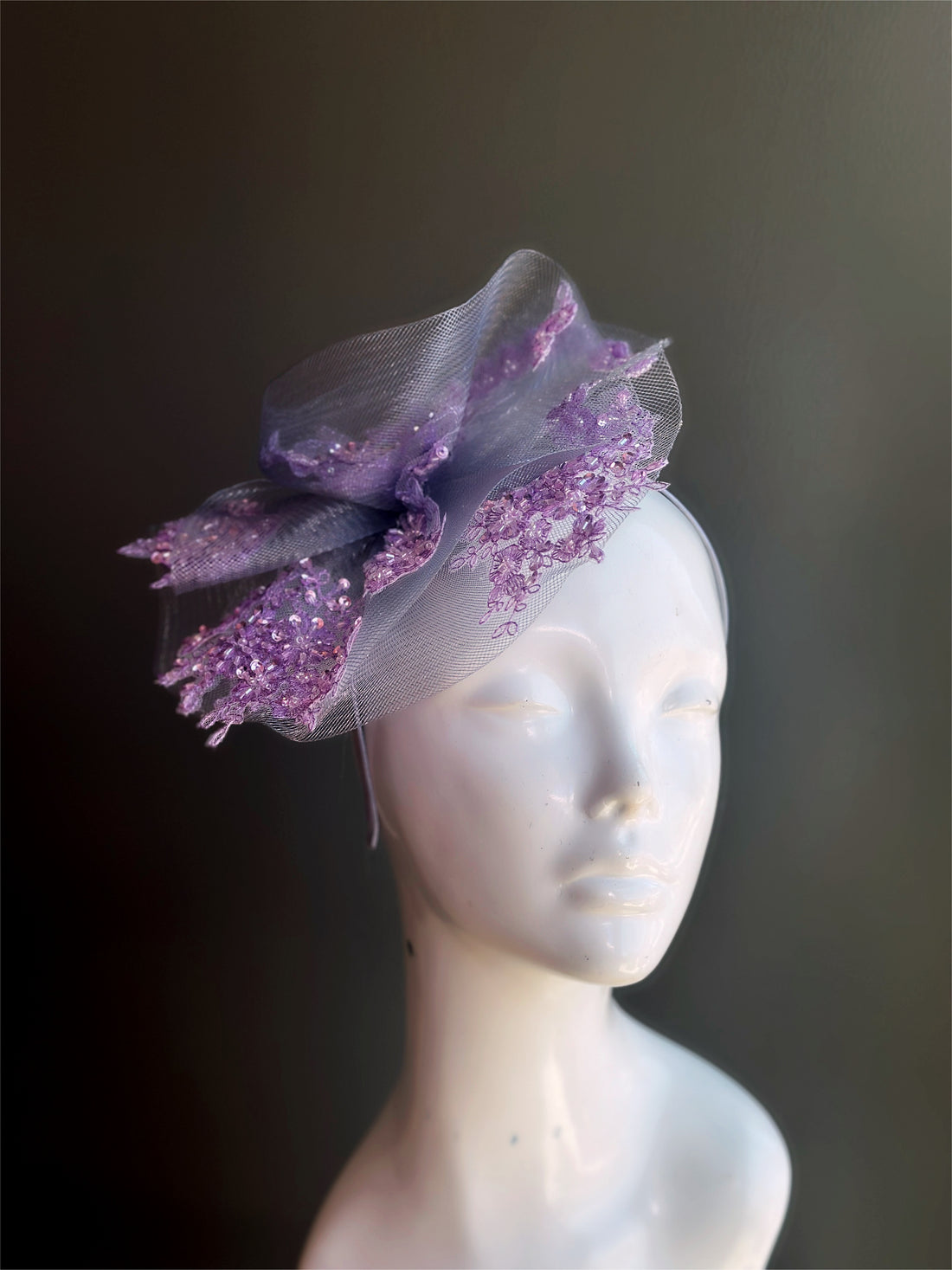 Silver fascinator tulle base with purple lace.