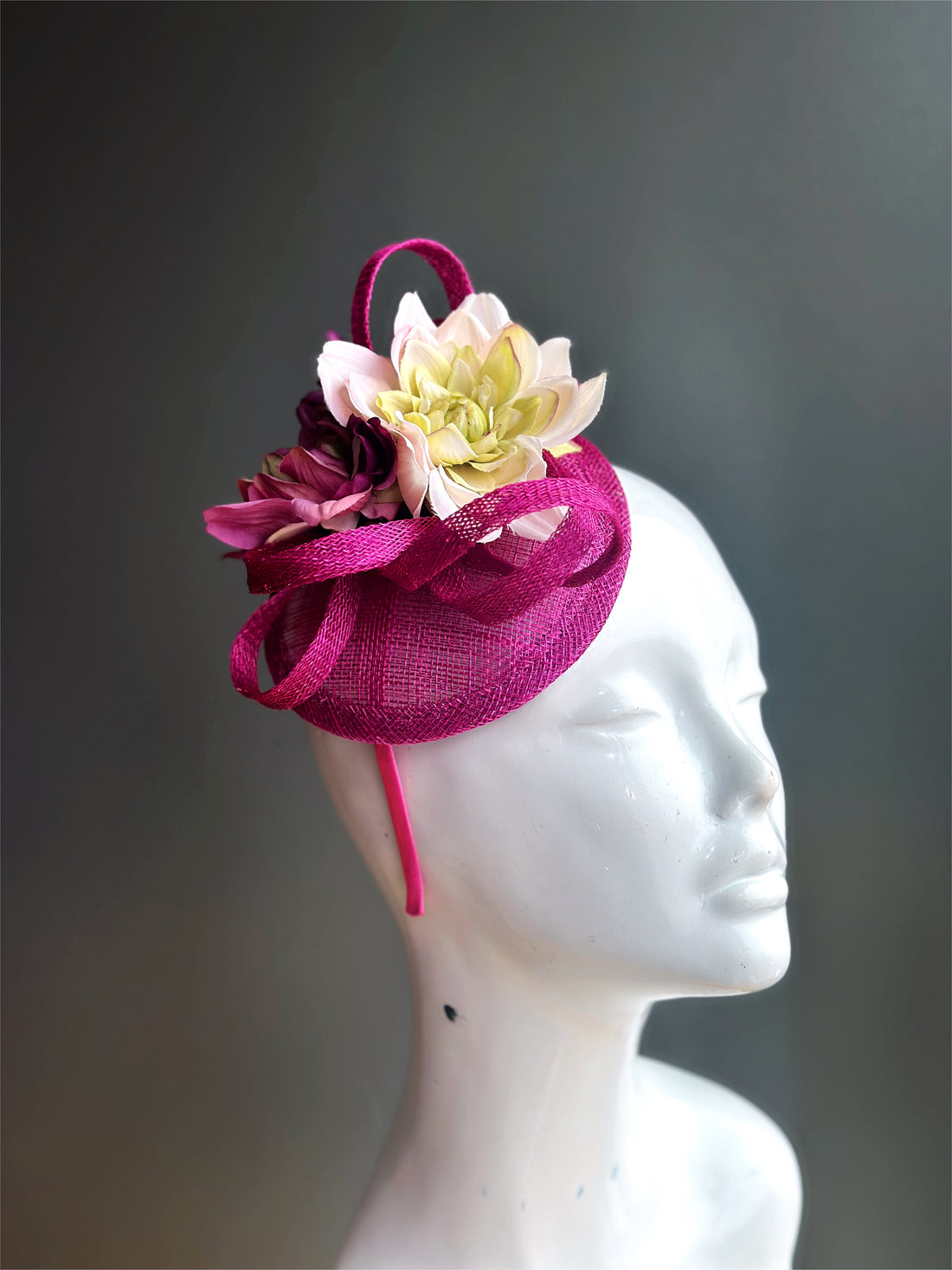 Pink fascinator hat base with flowers.