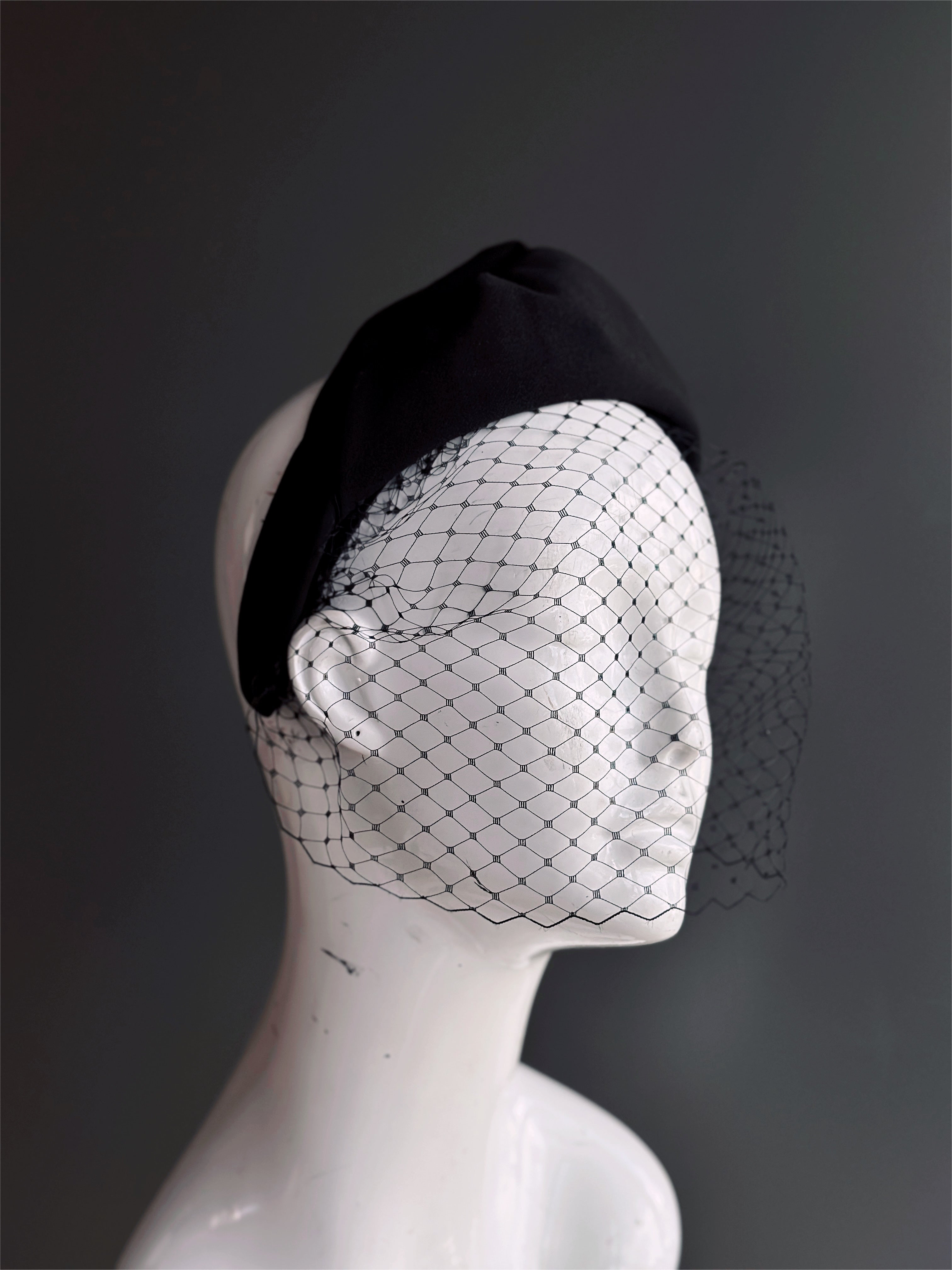 Headband with fishnet veil.