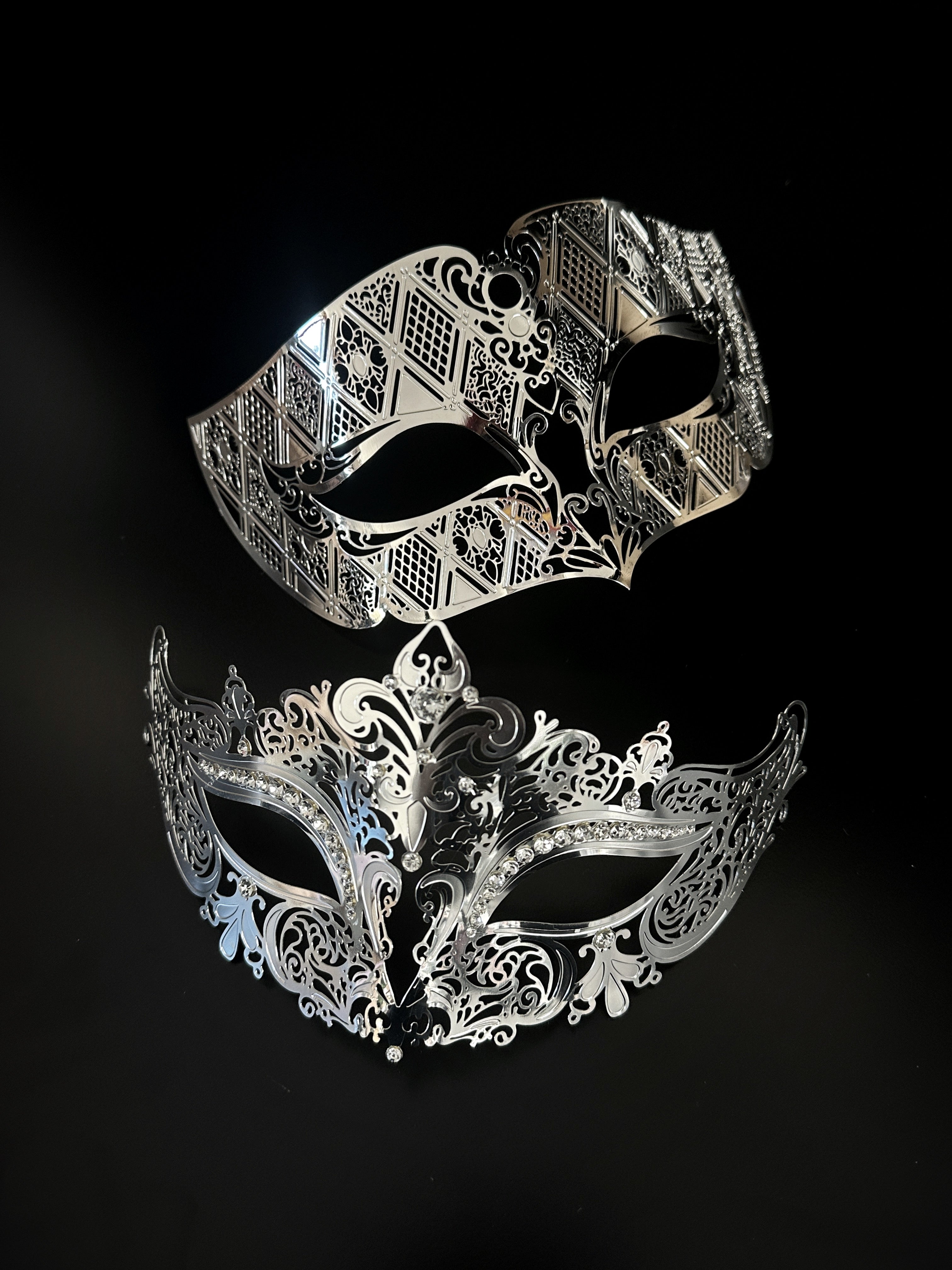 Laser cut metal masquerade mask set in silver.