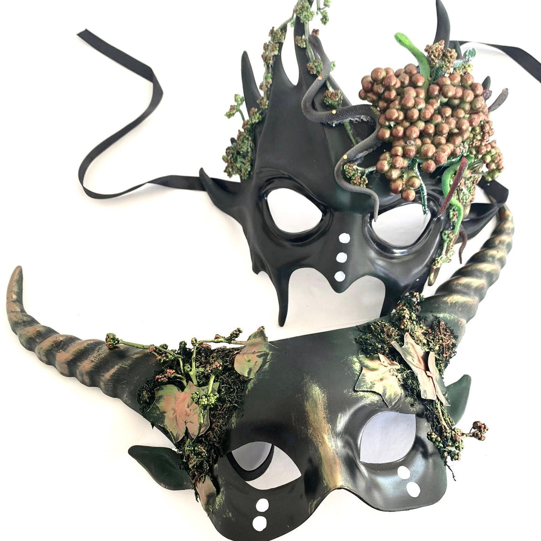 couples horned masquerade masks with leaves and moss.