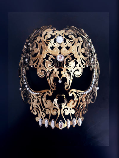 Men's metal skull masquerade mask in gold with rhinestones.