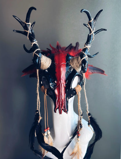 Black and red antler headdress with jute bindings, feathers, and tribal detailing.