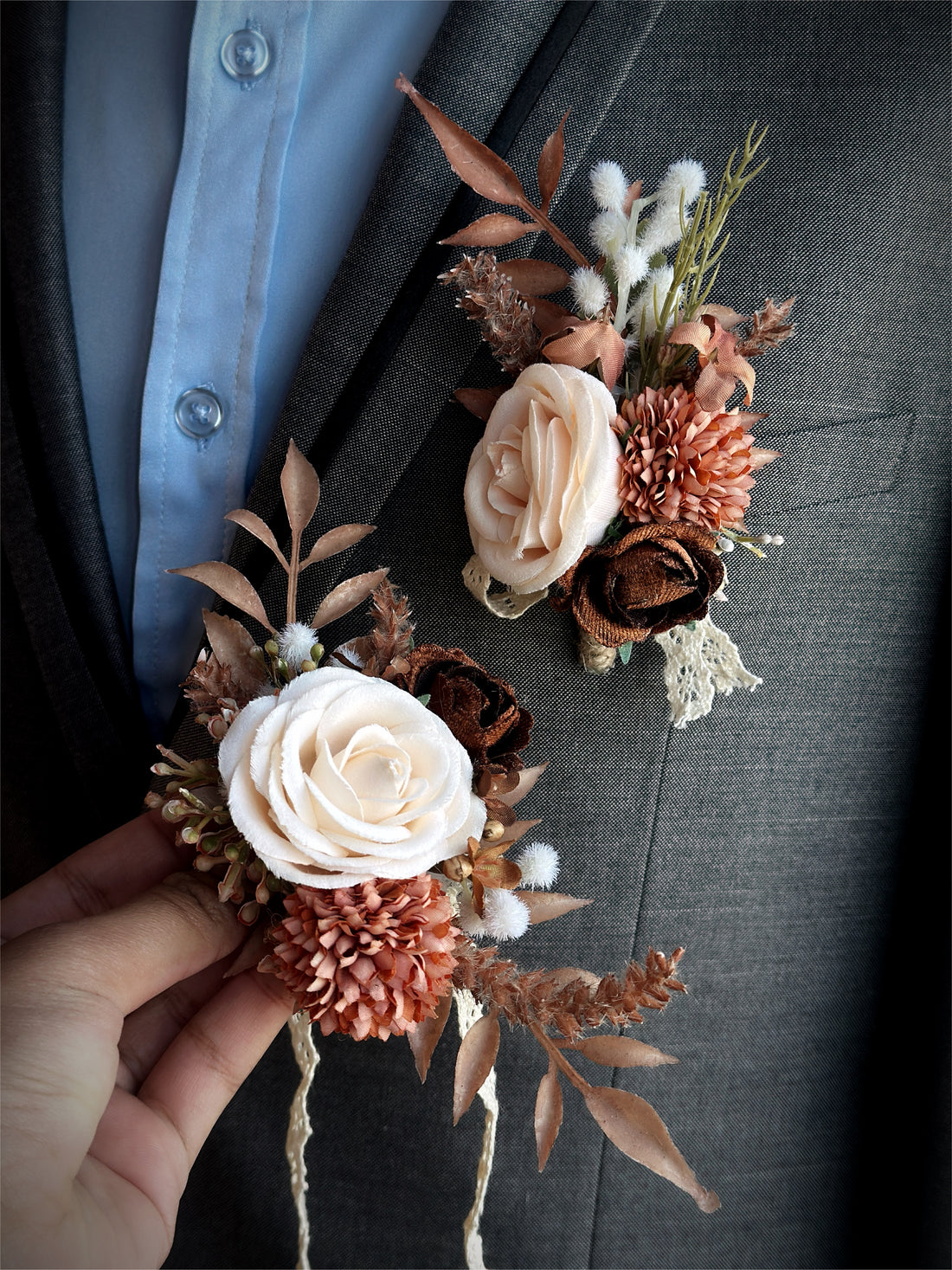 A beautifully crafted artificial floral boutonniere and corsage set featuring roses in shades of rustic peaches and creams, inspired by a rustic woodland charm.