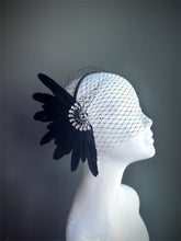 "Black feather fascinator with a crystal accent and a delicate mesh veil, perfect for weddings and vintage-themed events."

