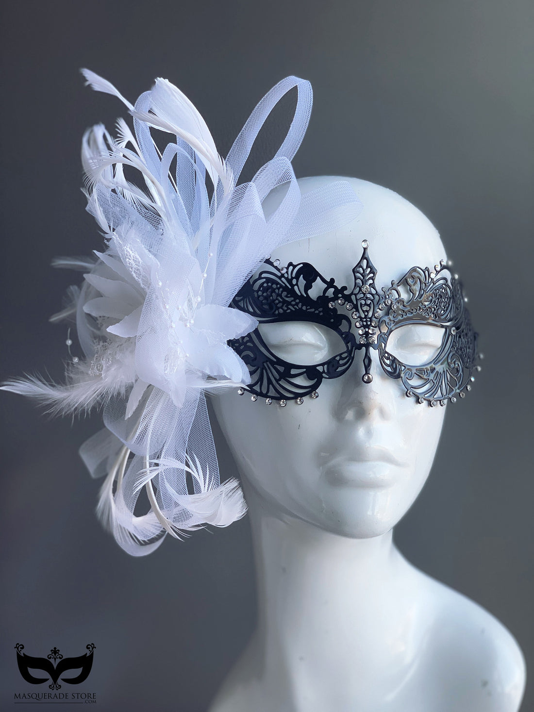 Black metal filigree mask with feathers and tulle