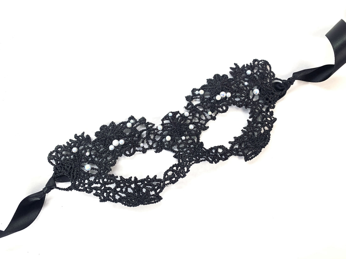 Black lace masquerade mask with pearls and intricate floral design