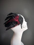 Black and red feather fascinator with beaded details and birdcage veil, perfect for Gatsby-themed parties and formal events.

