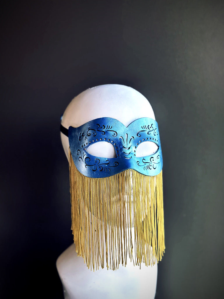 Blue masquerade mask with embossed details and gold fringe, ideal for Mardi Gras, masquerade balls, and costume events.