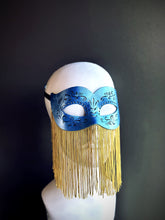 Blue masquerade mask with embossed details and gold fringe, ideal for Mardi Gras, masquerade balls, and costume events.