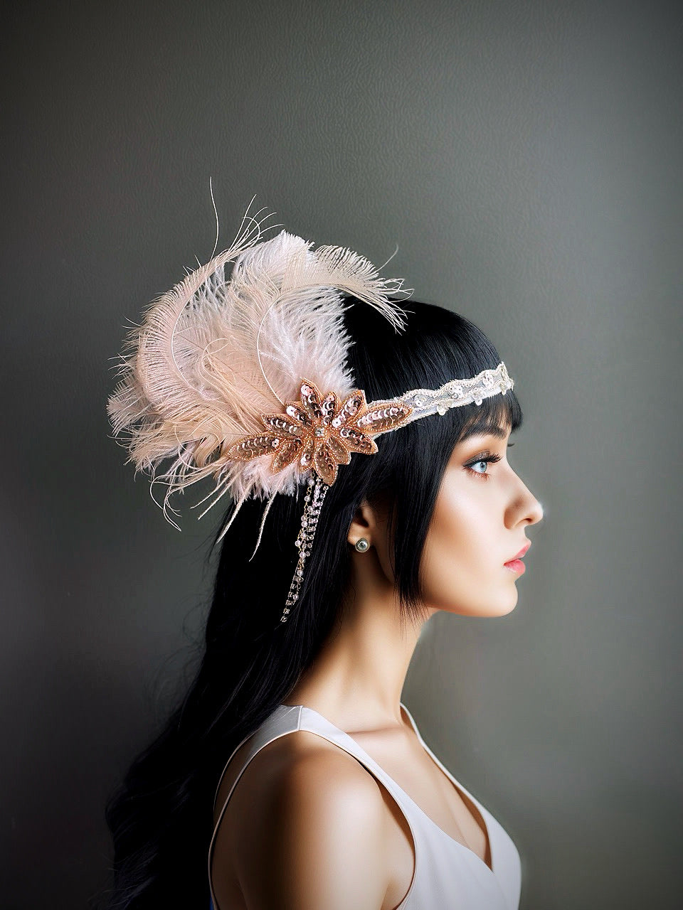 Blush pink flapper headband with feathers, crystals, and sequin accents, perfect for Gatsby-themed parties and weddings.

