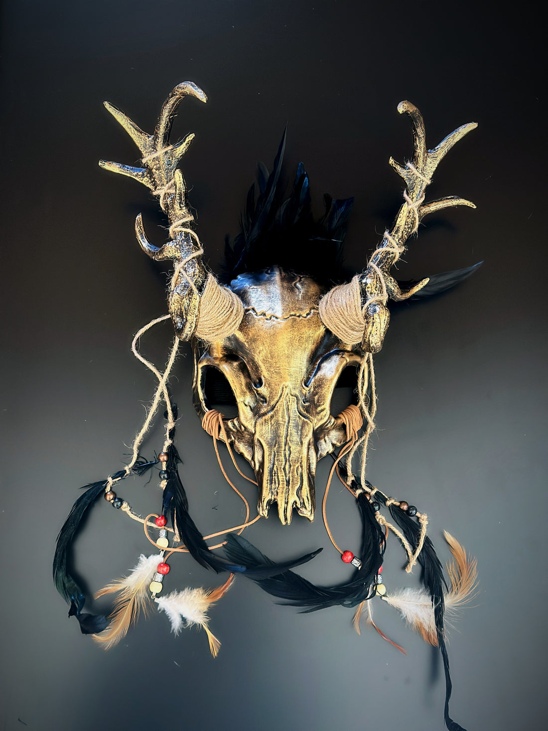 Celtic pagan antler skull headdress with twine-wrapped horns, feathers, and a mystical handcrafted finish.