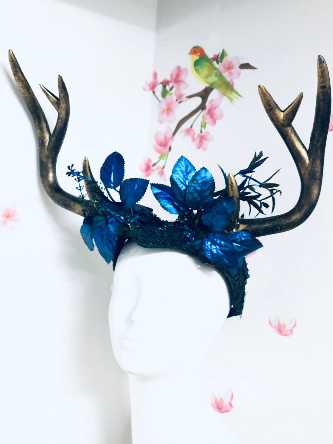 Deer antler mythical headdress with gold antlers and blue leaf accents, perfect for fantasy events and cosplay.