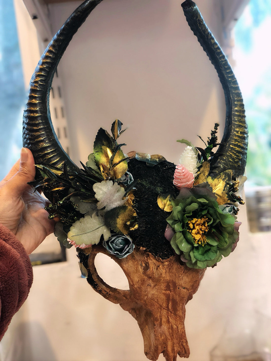 Gaelic Forest ram horn headdress with moss, greenery, and floral embellishments.