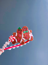 A festive Christmas headband decorated with gingerbread figures, peppermint candy accents, and red and white ribbon. Ideal for holiday celebrations.