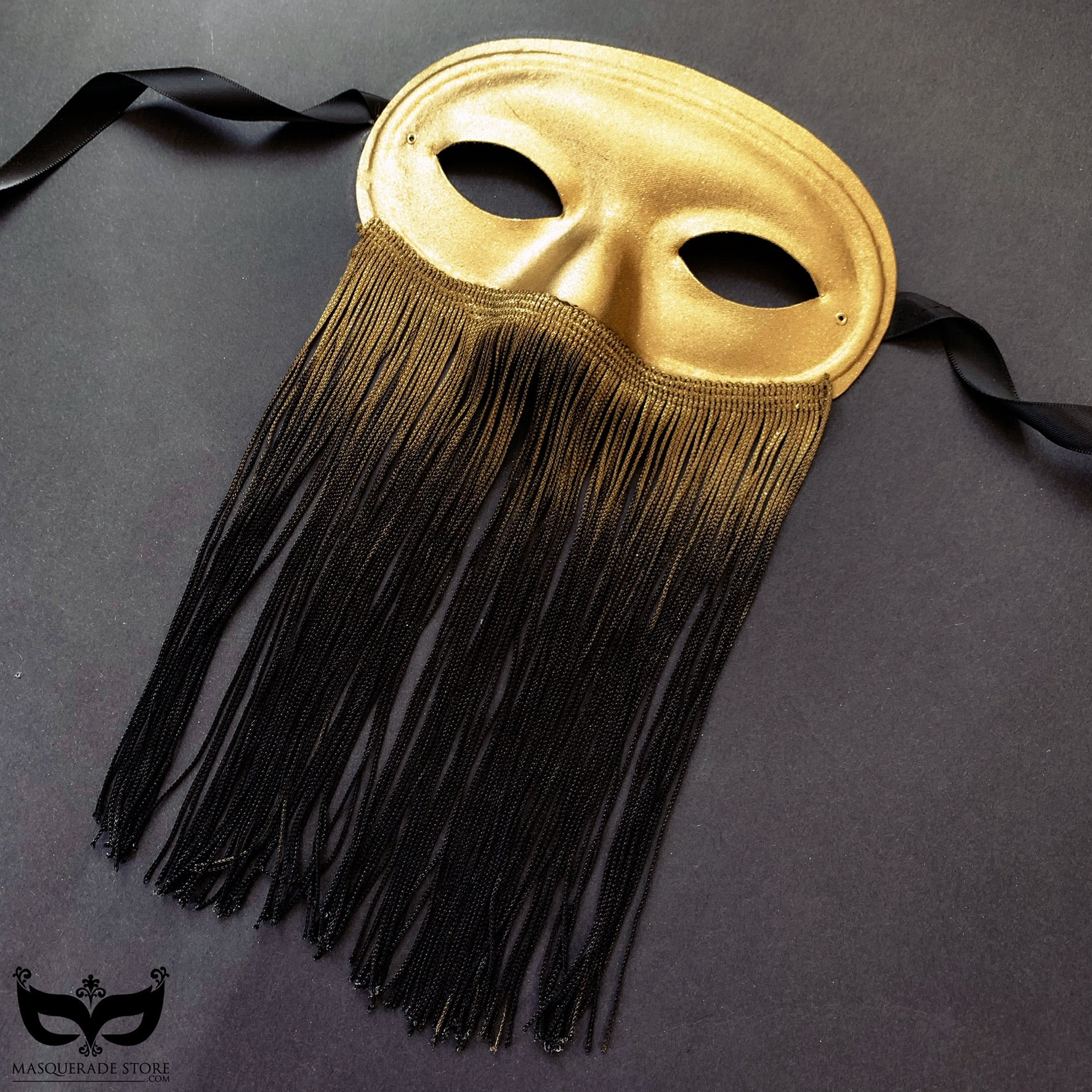 Gold mask with cascading ombre fringe transitioning from gold to black, perfect for masquerades, themed events, and performances.