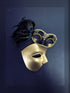 Gold and black Venetian-style couple masks, one with an elegant peacock feather accent, ideal for masquerade balls or themed events.