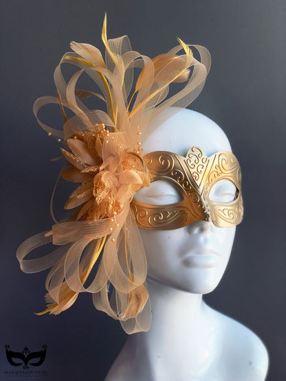 Gold plastic masquerade mask with feathers and tulle accents