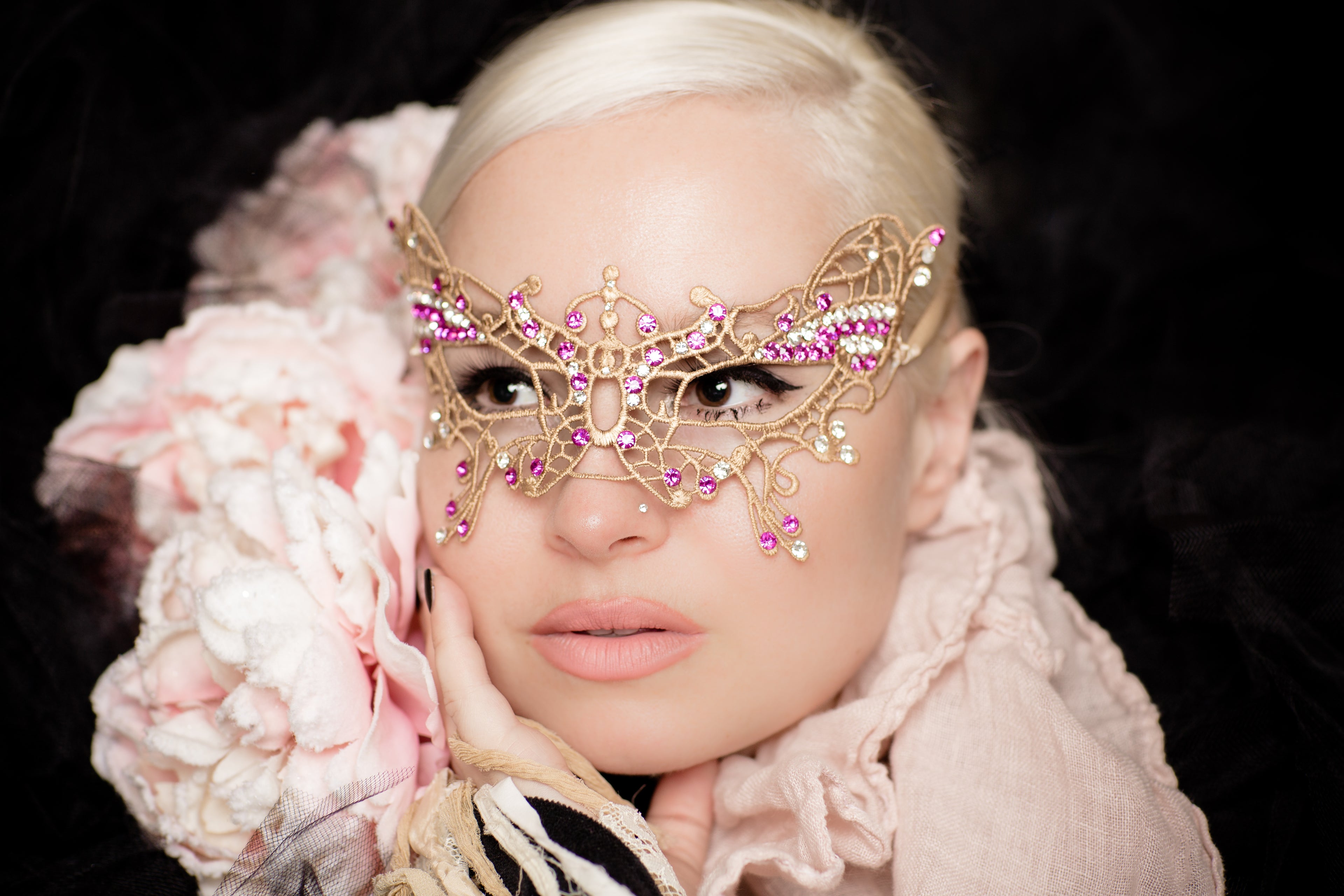 Luxurious gold lace butterfly mask with pink and clear rhinestone details, perfect for masquerades, weddings, and elegant costume events.