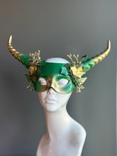 Green and gold horned mask with forest-inspired details and golden floral embellishments, ideal for fantasy or woodland-themed events.