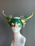 Green and gold horned mask with forest-inspired details and golden floral embellishments, ideal for fantasy or woodland-themed events.