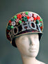 A festive Christmas hat decorated with candy-themed details, sparkling "Ho Ho Ho" lettering, and holiday colors. Perfect for seasonal celebrations.