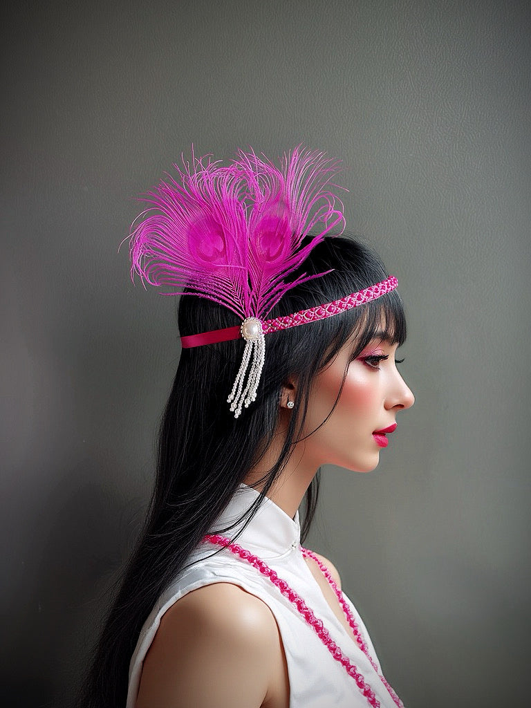 Hot pink flapper headband with peacock feather, pearl tassels, and rhinestone embellishments, ideal for Gatsby-themed events.

