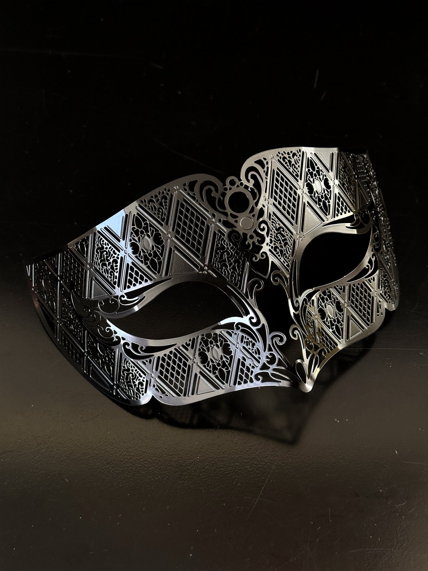 Close-up of intricate silver masquerade mask - detailed costume piece