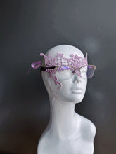 Lavender lace mask designed for eyeglass wearers on a white mannequin head