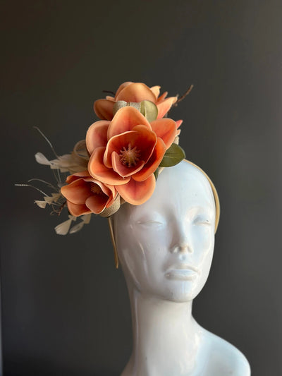 Magnolia fascinator headpiece with sinamay flowers in orange and peach, perfect for fall season events