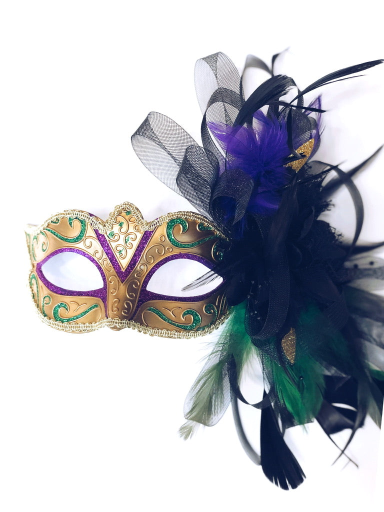 Mardi Gras Carnival Splendor Mask Duo featuring a purple and gold glitter mask with green accents and feather embellishments.