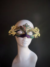 Purple and green Mardi Gras mask with elaborate gold filigree and sparkling rhinestones, designed for an elegant and eye-catching look.