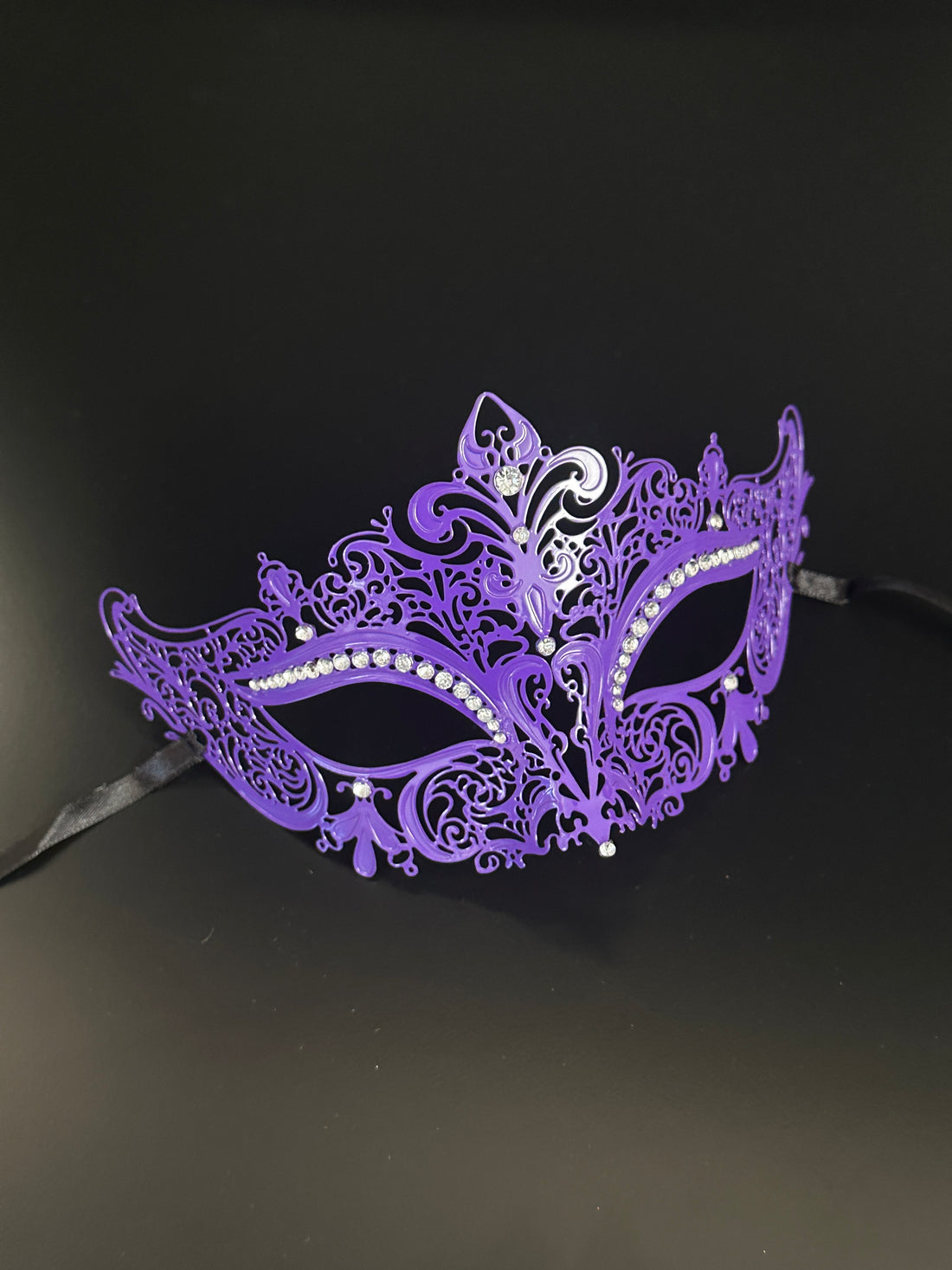 Ornate purple masquerade mask with intricate designs and rhinestones, ideal for masquerade balls and costume events.