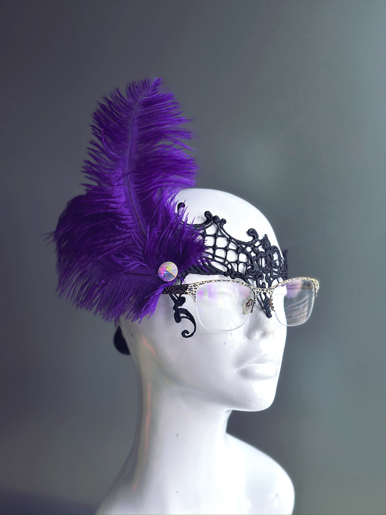 Purple Feather Masquerade Mask with black lace, designed to fit over glasses, featuring a vibrant purple feather.