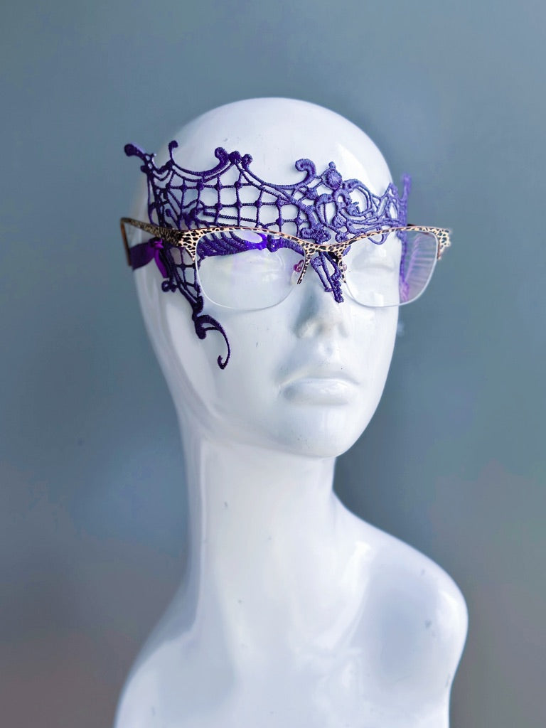 Purple lace mask designed for eyeglass wearers on a white mannequin head