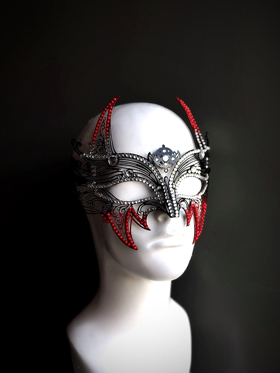 Wolverine-inspired mask with striking red and black metal accents, ideal for cosplay, themed parties, or dramatic masquerade events.