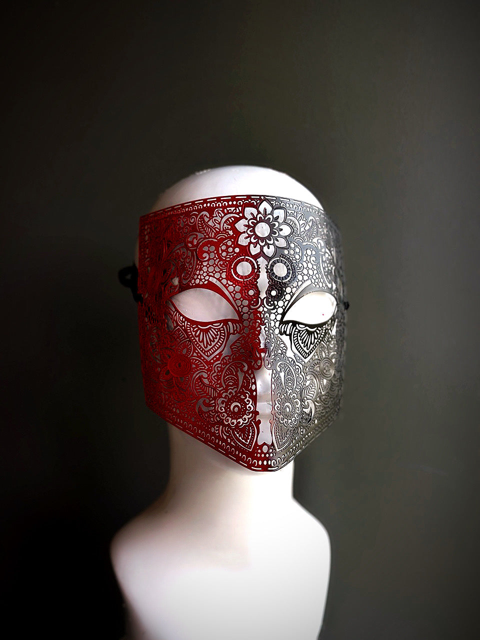 Red and silver full-face mask with intricate lace-like floral patterns, ideal for elegant occasions and formal masquerade events.
