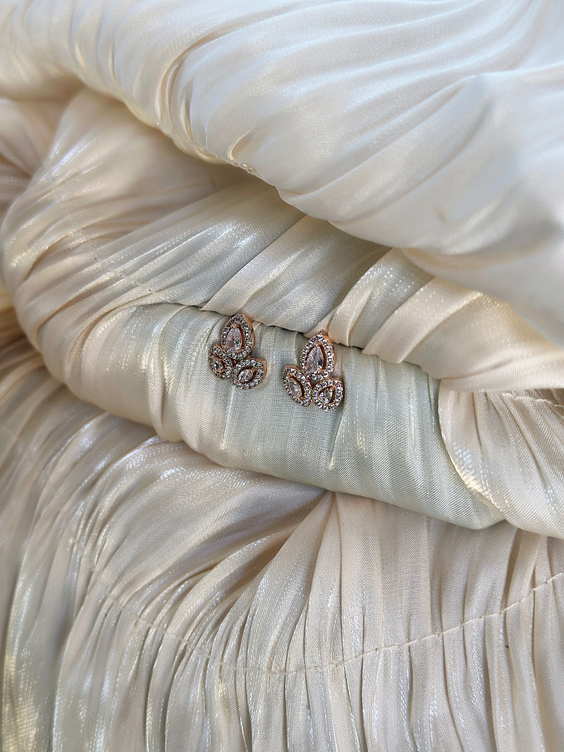 Rose gold fleur earrings with sparkling cubic zirconia stones, perfect for adding elegance to any outfit.