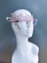 Rose gold lace mask designed for eyeglass wearers on a white mannequin head