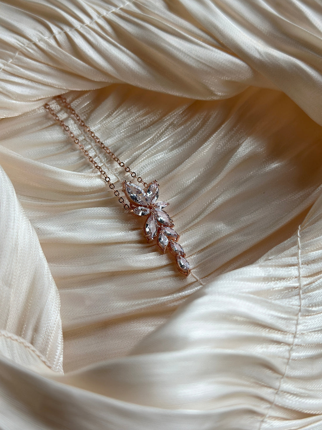 Rose gold necklace with marquise-cut crystals in a cascading floral-inspired design.