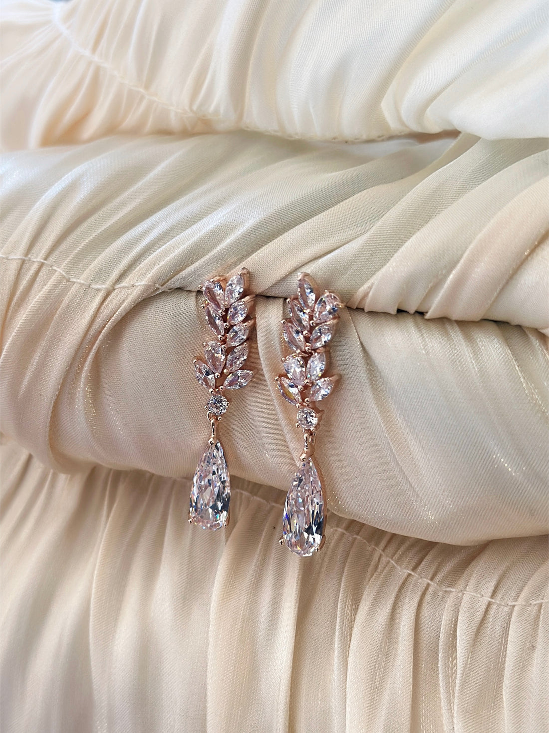 Elegant rose gold vine earrings with sparkling crystals and teardrop dangles for a sophisticated touch.