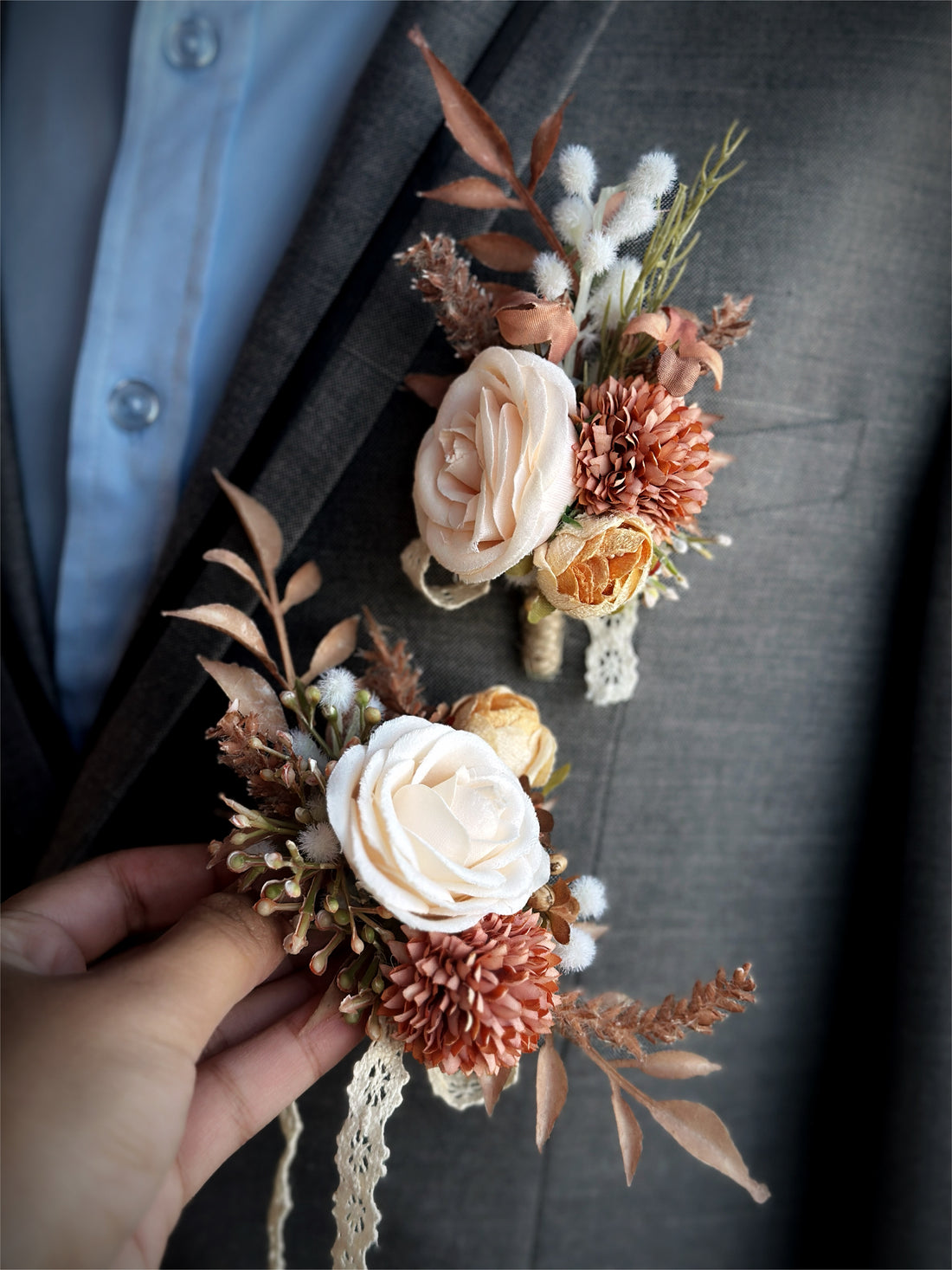 A beautifully crafted artificial floral boutonniere and corsage set featuring roses in shades of rustic peaches and creams,