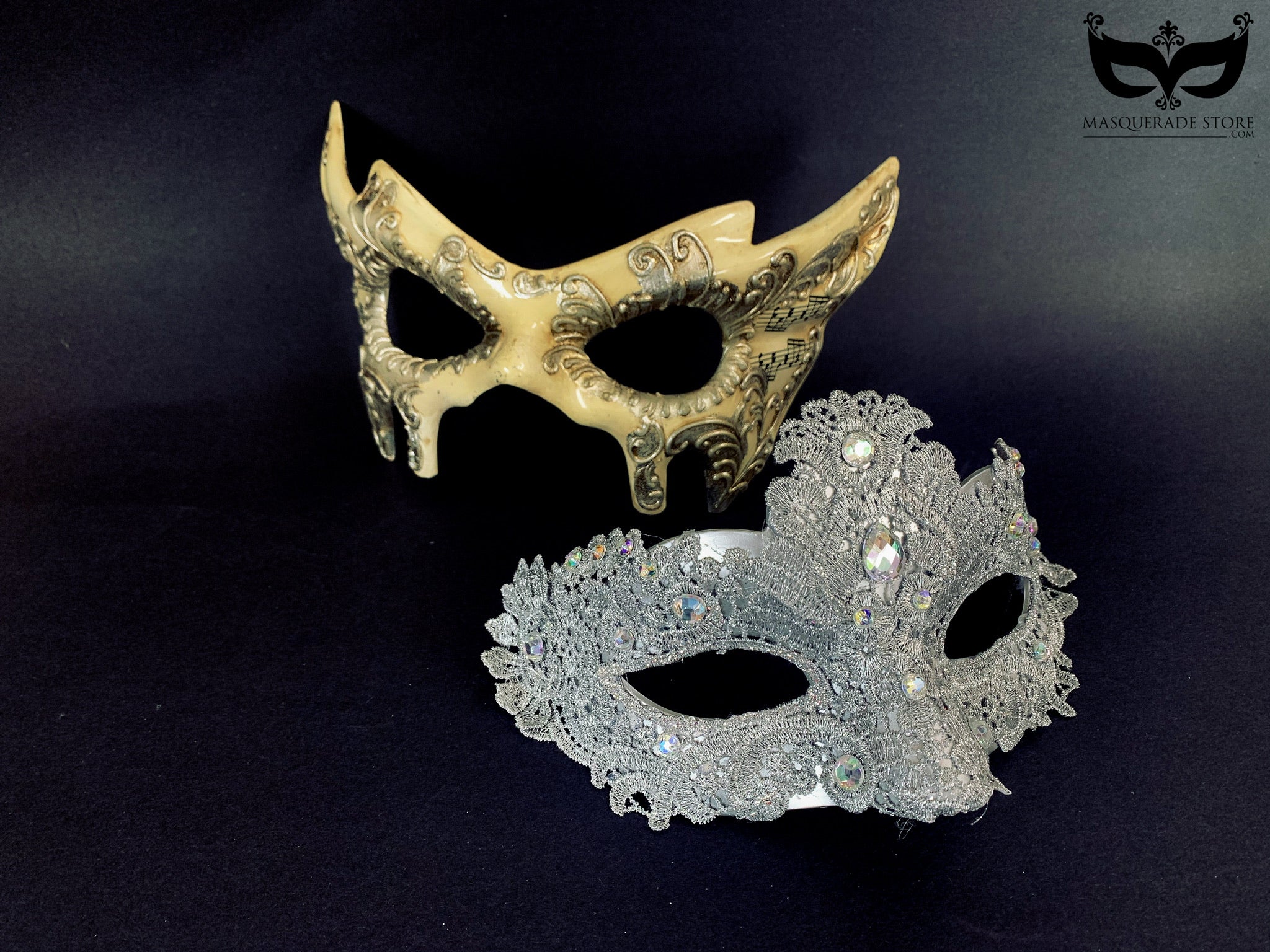 Silver lace mask with crystal accents paired with a vintage-inspired mask featuring music notes.