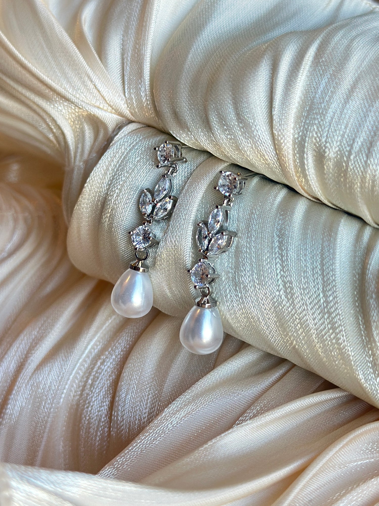 Silver drop earrings adorned with crystals and pearls, hypoallergenic, non-tarnish, and waterproof—ideal for brides and formal occasions.