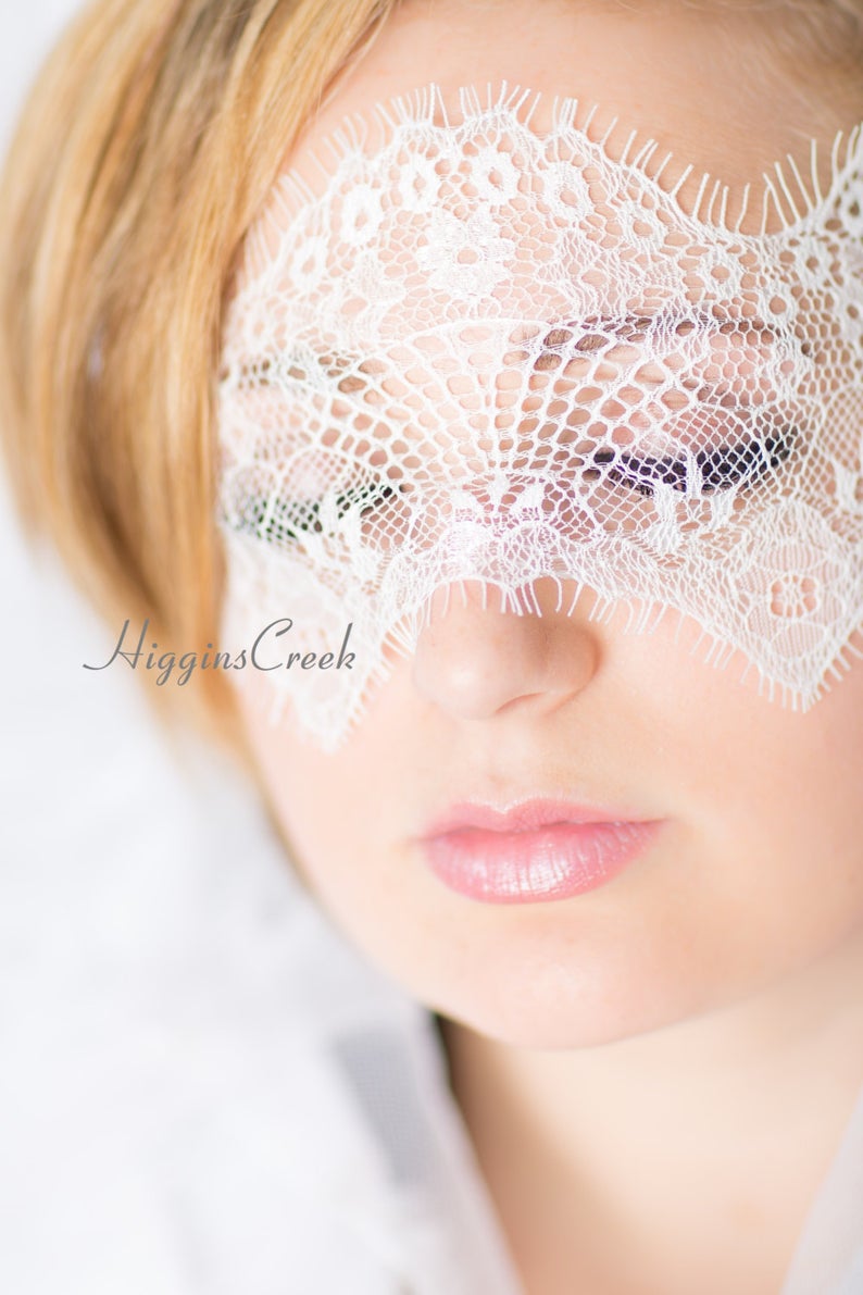 A soft and intricate white lace blindfold, ideal for Valentine&